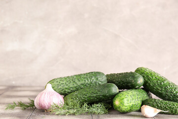 Heap of fresh cucumbers with garlic on table