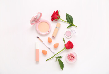 Composition with makeup products and beautiful red rose flowers on white background
