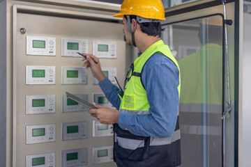 HVAC Technician Checking and Inspecting Control Panel