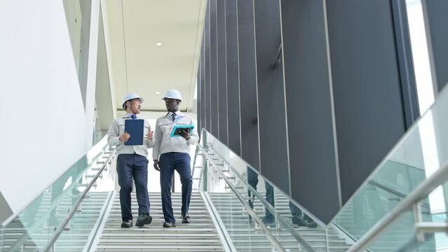 Group of multinational engineers having a conversation in a building