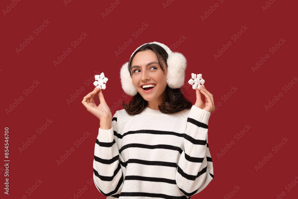 Sticker Happy young woman with decorative snowflakes on red background