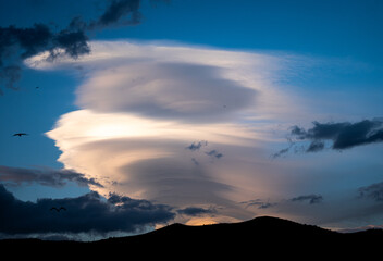 Lenticular Clouds Over Mountains