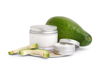 Jars of cosmetic products and fresh avocado on white background