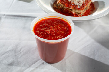 A view of a large container of marinara sauce.