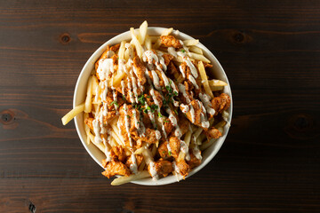 A top down view of a bowl of chicken shawarma fries.