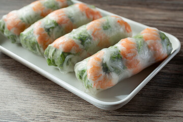 A closeup view of a plate of spring rolls.