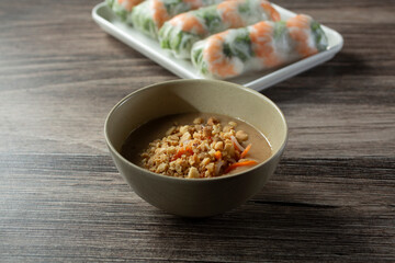 A view of a small bowl of dipping sauce for spring rolls.