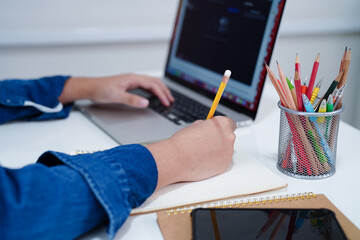 Asian teenage student write homework with laptop computer, learning university education concept.