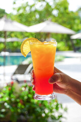  hands holding cocktail. glass of cocktail.