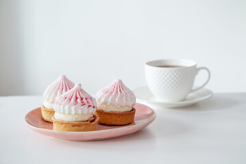 cupcakes with cup of coffee on white table