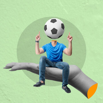 Man with soccer ball head sitting on giant hand pointing up with fingers
