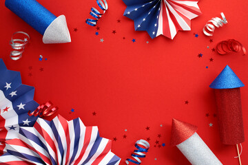 Patriotic decorations on red background for holiday. Flat lay paper fans, fireworks, party...