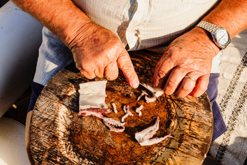 Hands of a fisherman preparing octopus bait, Es Trenc. Mallorca. Balearic Islands. Spain.