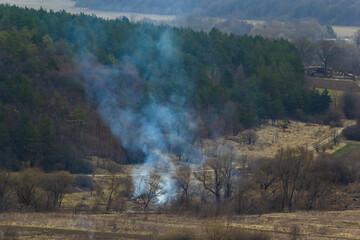 agricultural waste bonfires from dry grass and straw stubble burning with thick smoke polluting air...