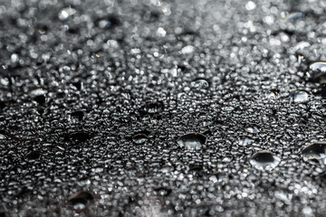 Drops of water on a color background. Selective focus. Gray