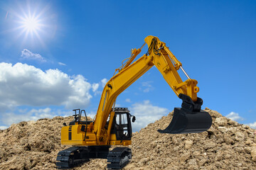 Excavators are digging the soil  in the construction site on the sky with sun background
