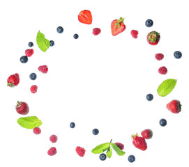 Frame made of flying different fresh berries and mint on white background