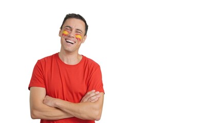 Man standing with spanish flag painted on face smiling