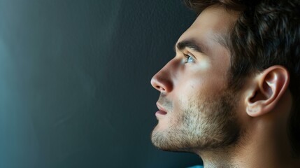 Profile pensive young man looking away on dark background, mouth person human eye