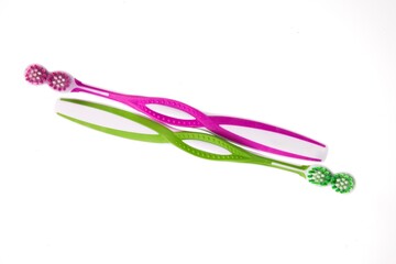 Closeup of two toothbrushes isolated on white background.