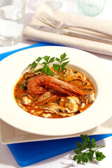 Kokotxas (cheeks of hake) with shrimps. Basque cuisine.
