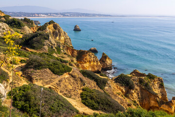 Cliffs at the edge of the ocean in Lagos in the Algarve in Portugal.