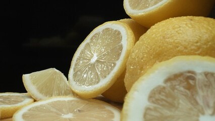 Close up of lemon slices are meticulously arranged against a rustic basket backdrop on a deep black...