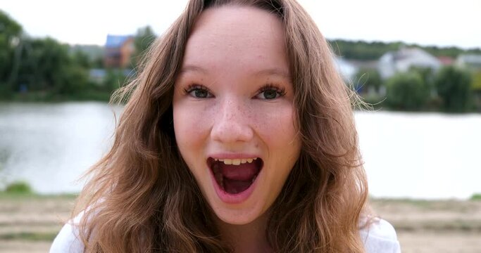 Bright emotions of a young teenage girl frown press smile be surprised with hands touch head with open mouth shock joy fun