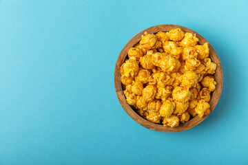 Caramel popcorn.Tasty popcorn in color background. Cinema and entertainment concept. Movie night with popcorn. Delicious appetizer, snack. Place for text. Copy space.Banner