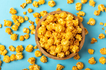 Caramel popcorn.Tasty popcorn in color background. Cinema and entertainment concept. Movie night with popcorn. Delicious appetizer, snack. Place for text. Copy space.Banner