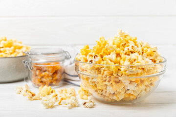 Tasty popcorn on woodenbackground. Cinema and entertainment concept. Movie night with popcorn.Cheese and caramel popcorn. Delicious appetizer, snack. Place for text. Copy space.Banner