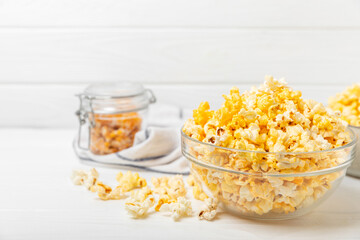 Tasty popcorn on woodenbackground. Cinema and entertainment concept. Movie night with...