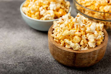 Tasty popcorn on woodenbackground. Cinema and entertainment concept. Movie night with...