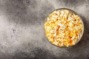 Tasty popcorn on woodenbackground. Cinema and entertainment concept. Movie night with...