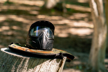 close-up of the wild nature on a wooden lacquered table there is ammunition pintball gun active...