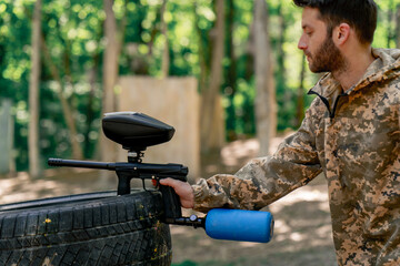 in the wild in for training paintball pistols with colored balls attached to a metal hanging...