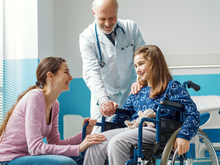 Doctor assisting a patient in wheelchair and her mother