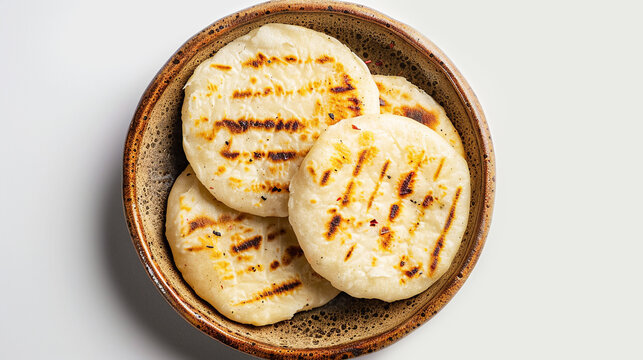 Cornmeal arepas on a plate on light grey background. Traditional flatbread typical for South and Central America countries