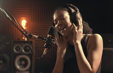 Woman recording an audio track in the studio