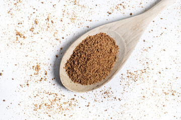 Coconut palm sugar on a wooden spoon isolated on white background