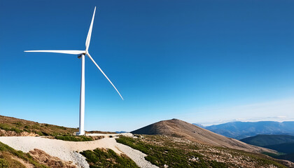 Wind turbines rise on hills under a clear sky, harnessing energy at dawn with copy space area.
