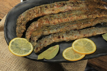 Fried whole lampreys on a plate, Fish delicacies, Latvian cuisine