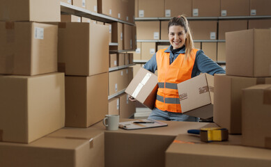 Portrait of a strong warehouse worker carrying boxes