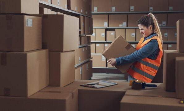 Warehouse worker lifting a heavy box