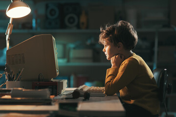 Nerd boy watching videos on a vintage computer
