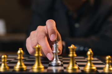 Businessman moves chess with strength, manages risk with vision of leadership, professional boss builds team to achieve goal.