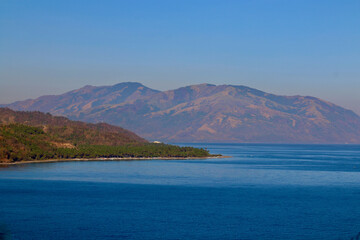 Fototapeta premium View of the mountains and sea. View of the island's mountainous coastline and calm ocean. 