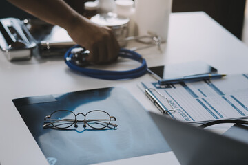 Stethoscope with prescription clipboard and Laptop ,Doctor working an Exam, Healthcare and medical concept,test results in background,vintage color,selective focus