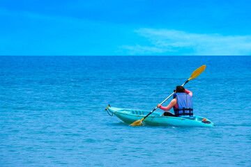 Fototapeta premium Aerial view of a kayak in the blue sea .man kayaking he does water sports activities. 