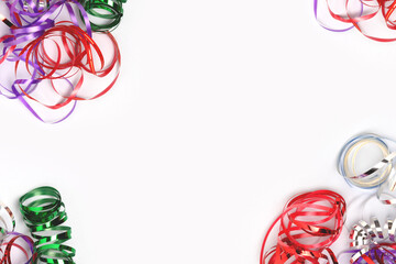 Frame made of ribbons on a blue background. Festive concept with copy space.